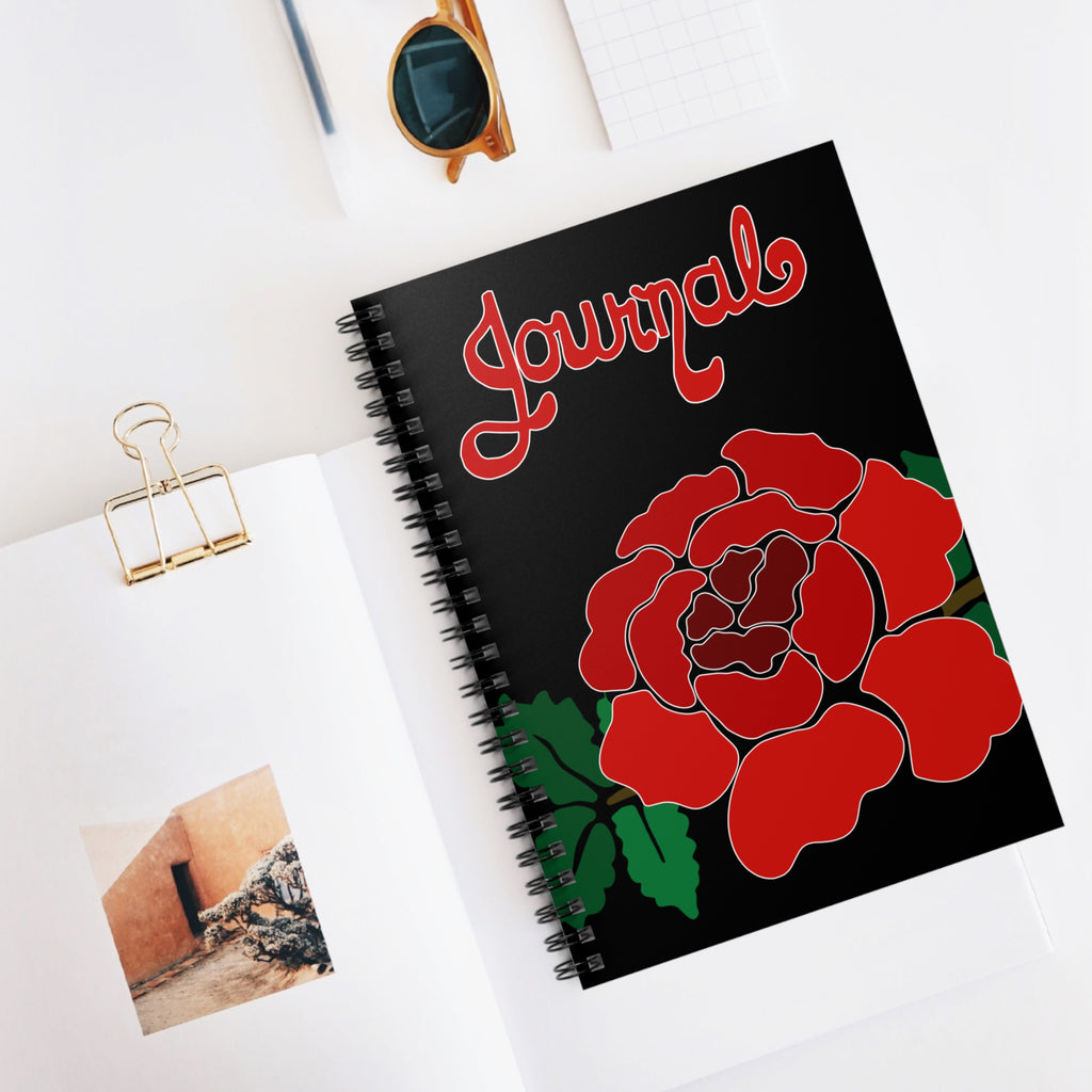 Journal with red rose design on a white surface