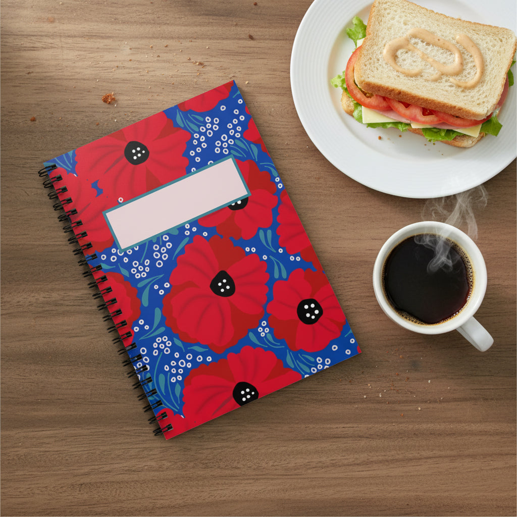 Red poppies illustrated notebook on table