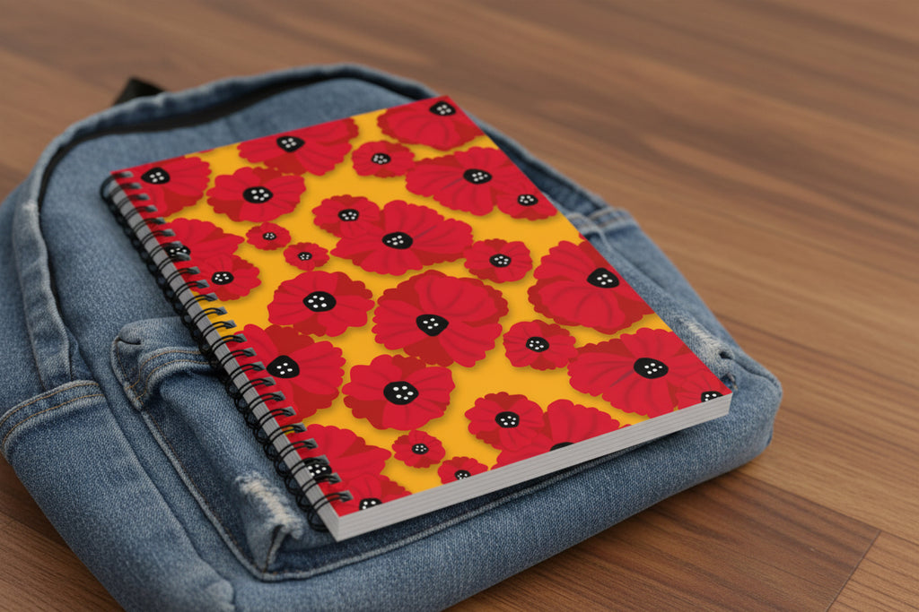Notebook with red floral pattern on a yellow background