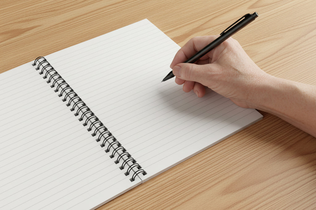 Open spiral-bound notebook on a wood background