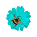 Bee on a turquoise flower with a white border