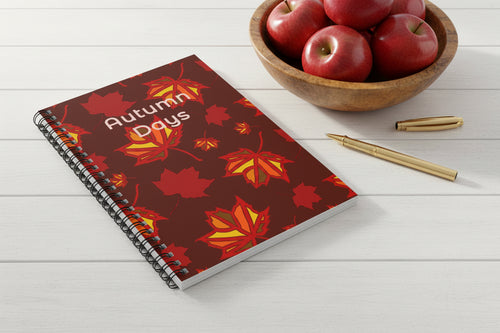 Notebook with autumn leaf design and 'Autumn Days' text.