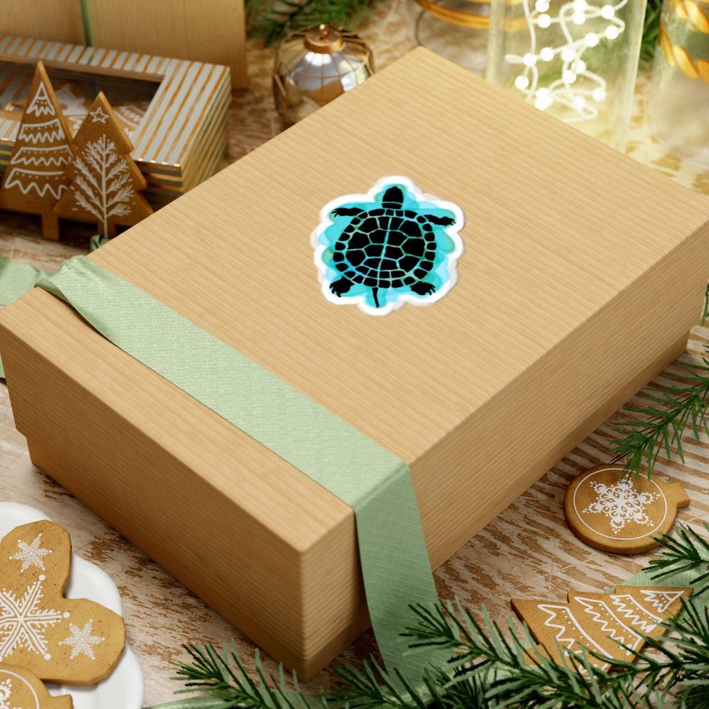 Gift box with a turtle design sticker on a festive background with cookies and decorations