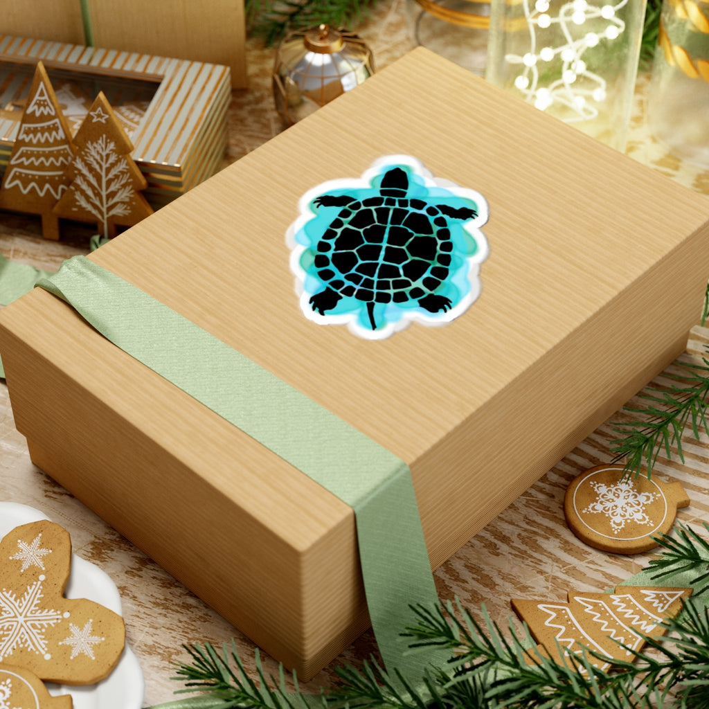 Wooden gift box with a turtle design sticker on a festive background with cookies and lights.