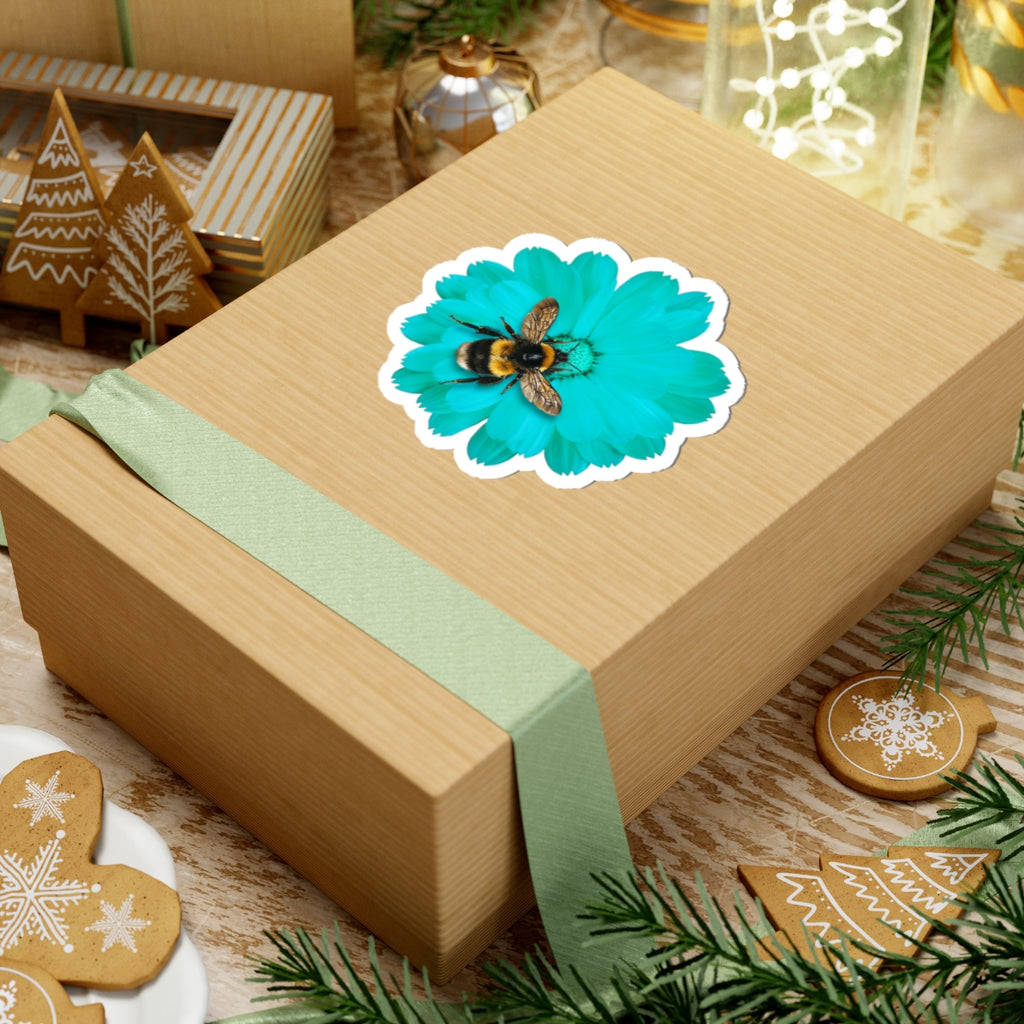 Wooden gift box with a bee and flower sticker on a festive background with cookies and lights.