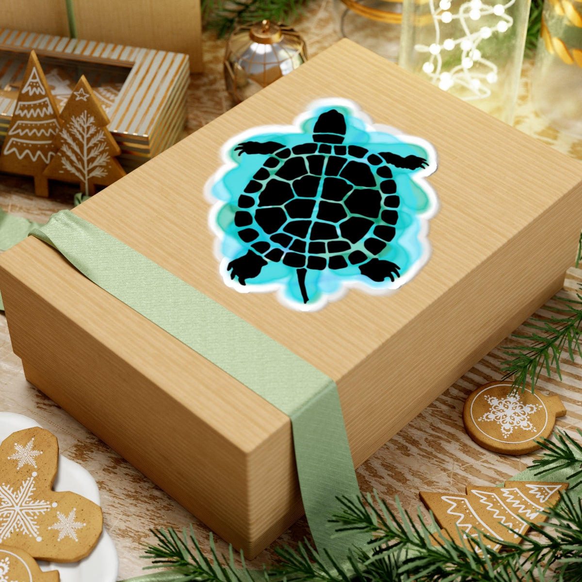 Wooden gift box with a turtle design and green ribbon, surrounded by festive decorations.