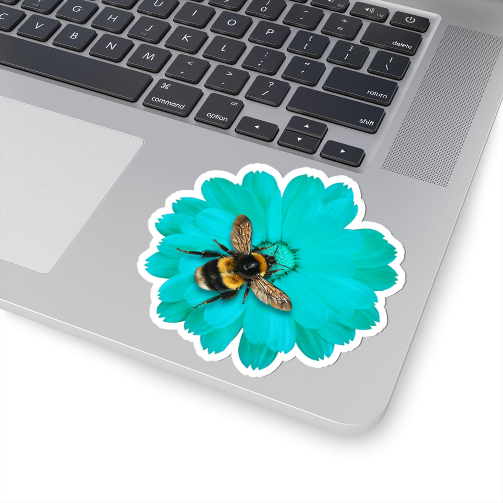 Sticker of a bee on a blue flower on a laptop keyboard