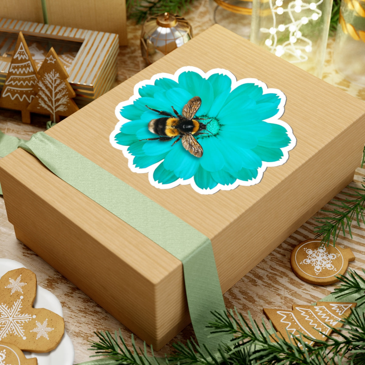Wooden gift box with a turquoise flower and bee design on a festive background with cookies and lights.