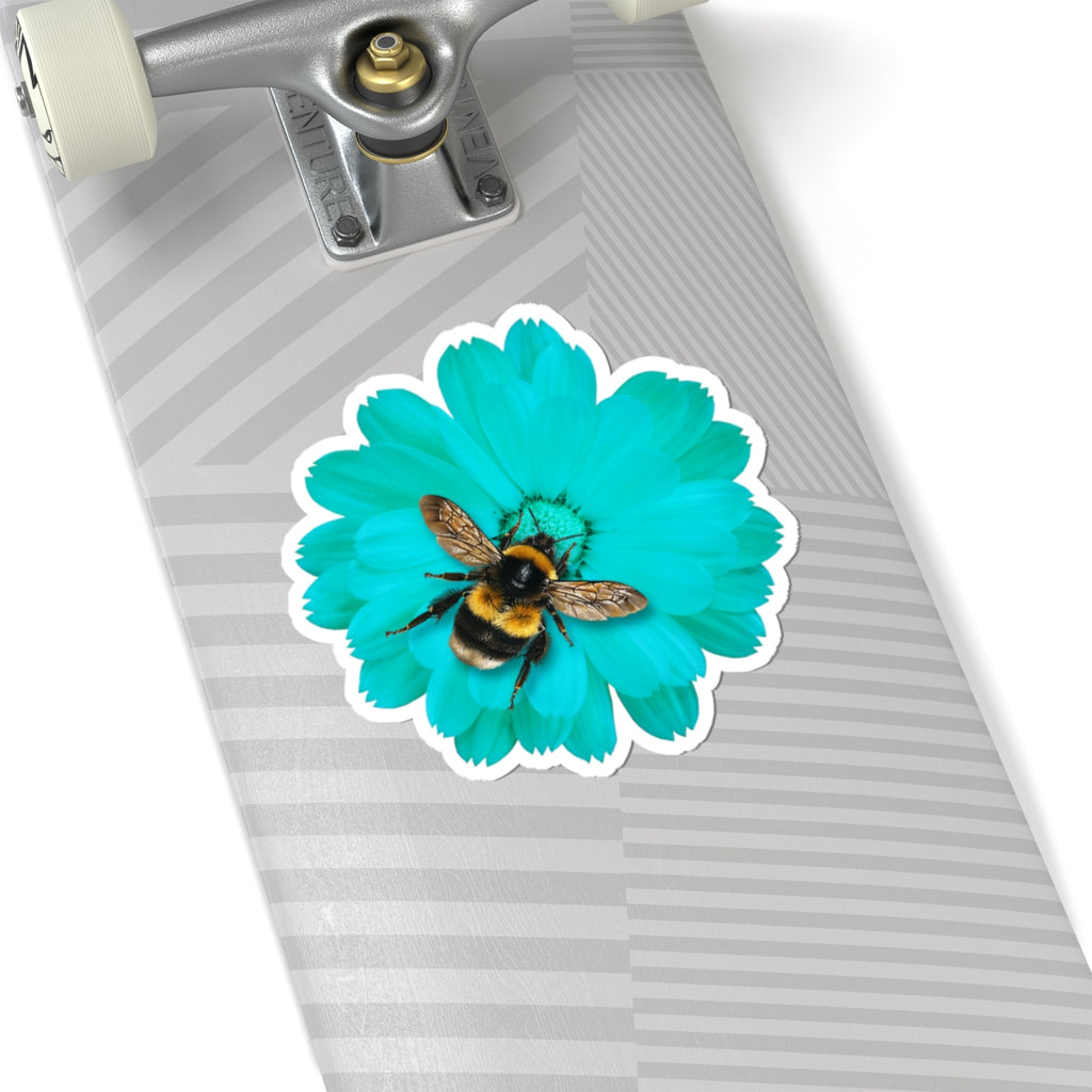 Skateboard with a turquoise flower and bee sticker on a white background